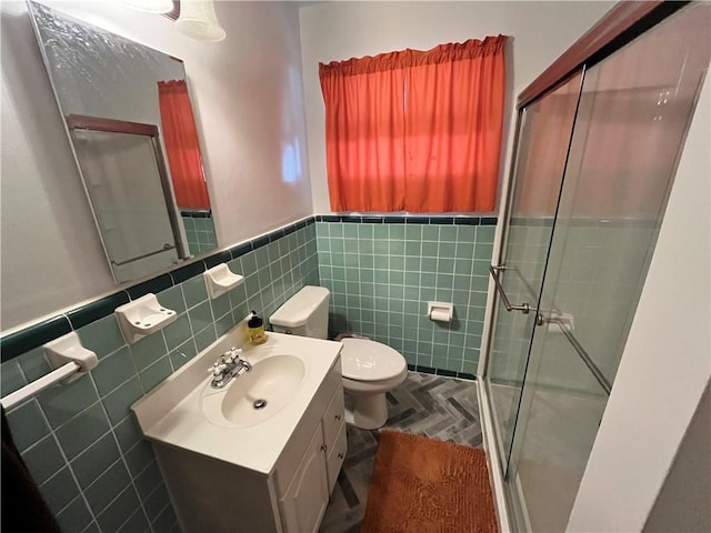 bathroom with walk in shower, vanity, tile patterned floors, and tile walls