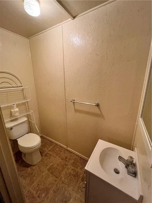 bathroom featuring vanity, toilet, and a textured ceiling