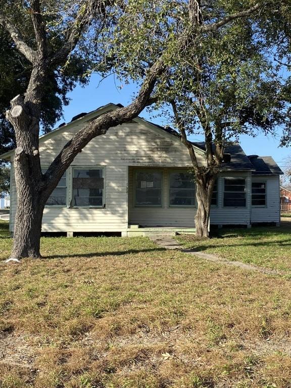 rear view of property with a lawn