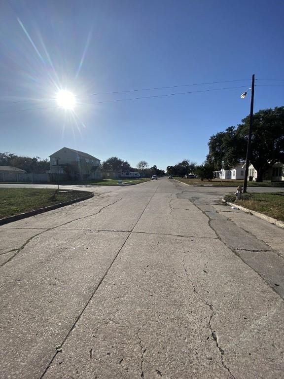view of road with street lighting and curbs