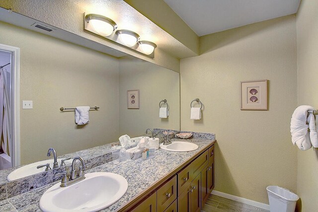 bathroom with vanity and hardwood / wood-style floors