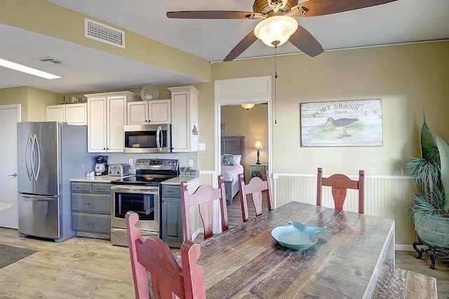 dining space featuring ceiling fan and light hardwood / wood-style flooring