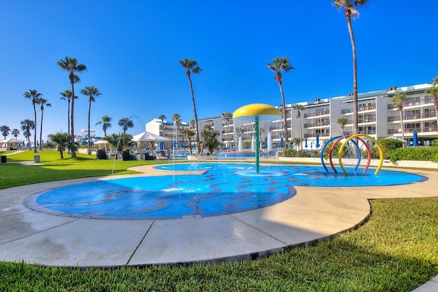 view of pool featuring a lawn