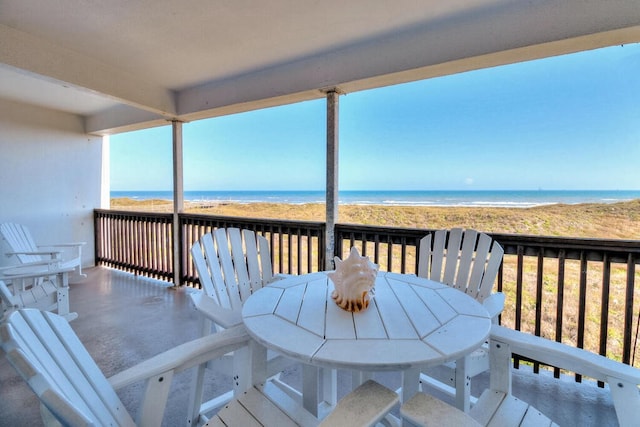 deck featuring a view of the beach and a water view