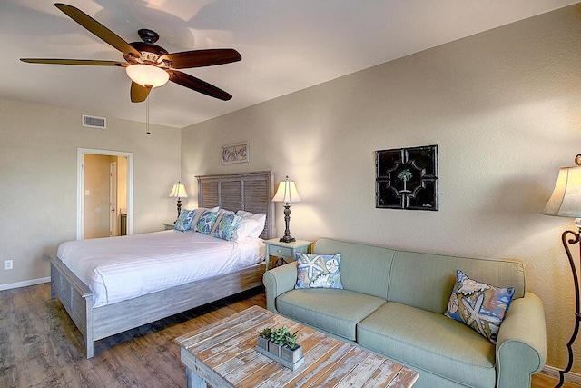 bedroom with ceiling fan and dark hardwood / wood-style floors