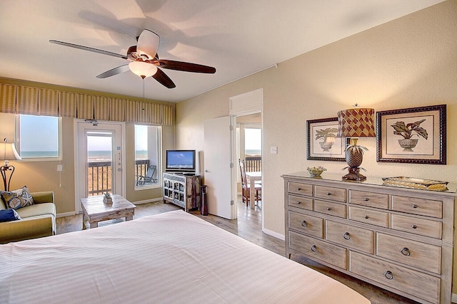 bedroom with light wood-type flooring, ceiling fan, multiple windows, and access to exterior