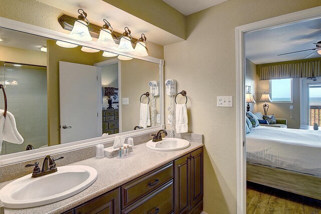 bathroom featuring ceiling fan, wood-type flooring, and vanity