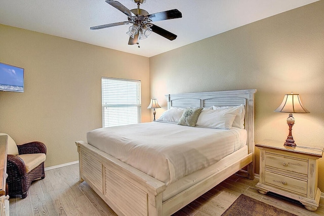 bedroom with ceiling fan and light hardwood / wood-style flooring