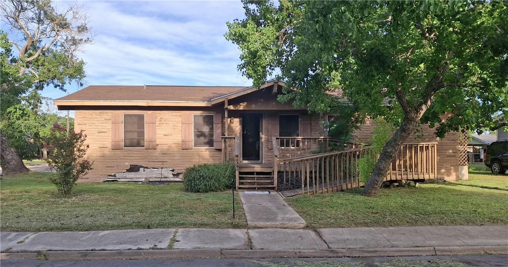 1702 Merriman Ave, Corpus Christi, TX 78412 - view of front of home featuring a front lawn and brick siding