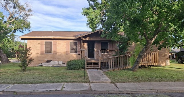1702 Merriman Ave, Corpus Christi, TX 78412 - view of front of home featuring a front lawn and brick siding