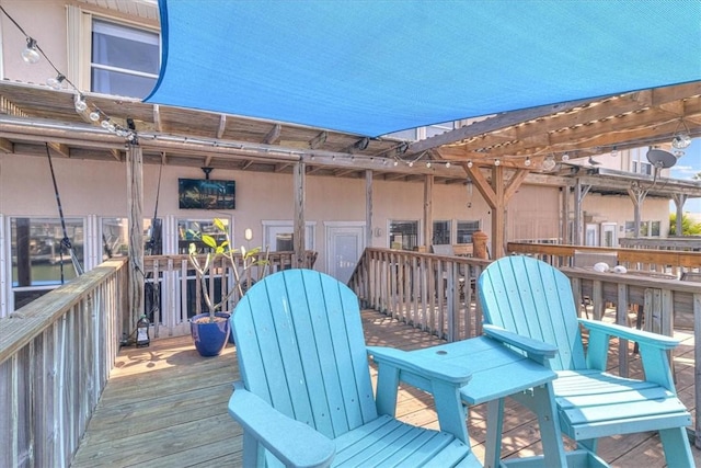 wooden terrace featuring a pergola and outdoor dining area