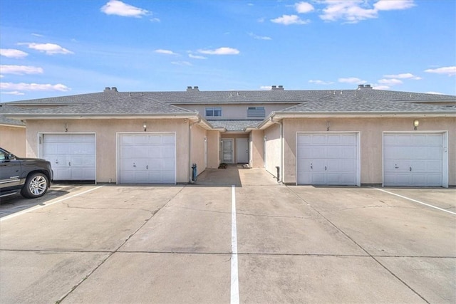 15433 Seamount Cay Ct Unit 4, Corpus Christi, TX 78418 - view of property featuring stucco siding and community garages