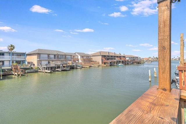 view of dock with a water view and a residential view