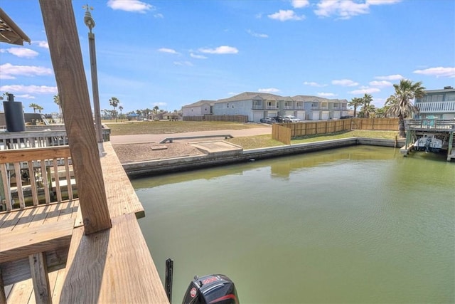 dock area with a residential view and a water view