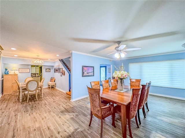 dining room featuring light wood-type flooring, ceiling fan, and ornamental molding