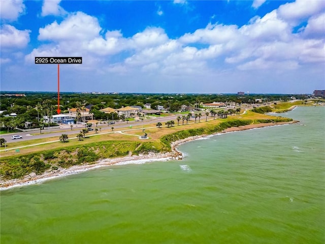 birds eye view of property with a water view and a view of the beach