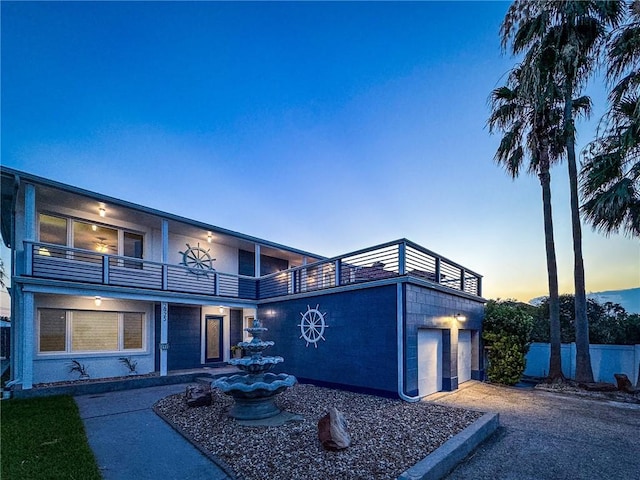 view of front of home featuring a balcony and a garage