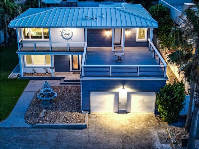 back of house featuring a balcony and a garage