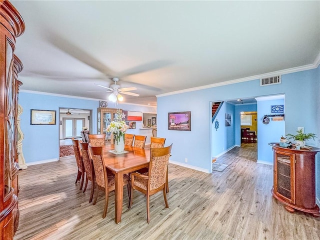 dining area with ceiling fan, light hardwood / wood-style flooring, and crown molding