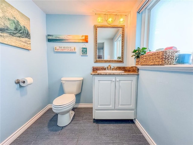 bathroom featuring toilet and vanity