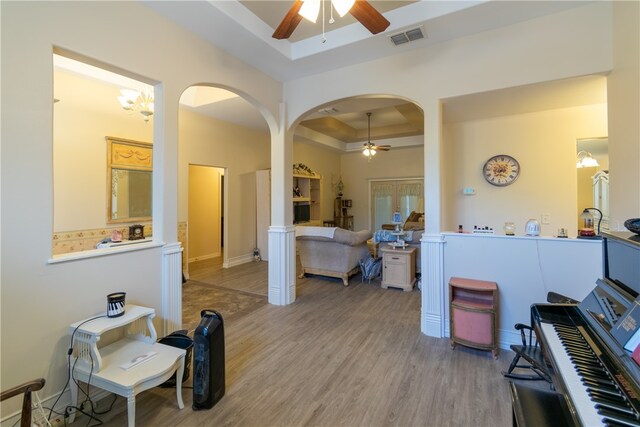 interior space featuring hardwood / wood-style flooring, a chandelier, and a tray ceiling