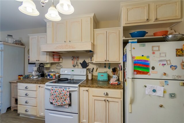 kitchen featuring pendant lighting, hardwood / wood-style floors, and white appliances