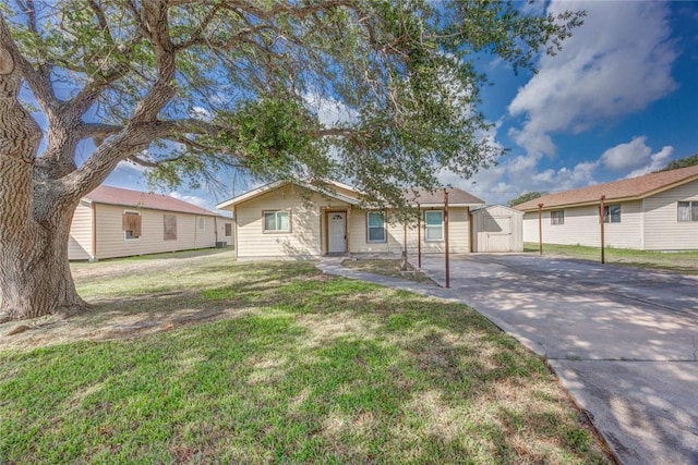 529 Blanco St, Taft, TX 78390 - ranch-style house with concrete driveway, a shed, and a front lawn