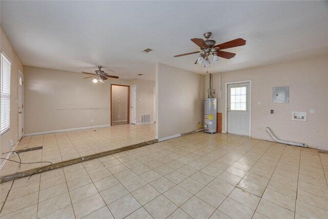 529 Blanco St, Taft, TX 78390 - spare room featuring ceiling fan, water heater, light tile patterned floors, and electric panel