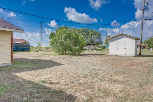 529 Blanco St, Taft, TX 78390 - view of green lawn featuring a storage unit