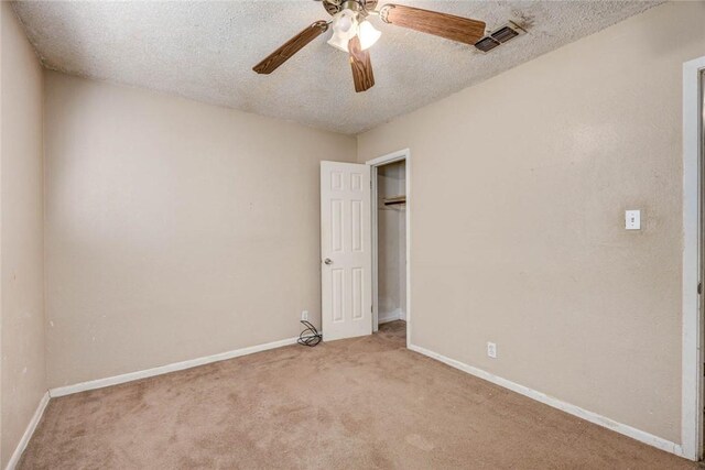 529 Blanco St, Taft, TX 78390 - unfurnished bedroom with carpet, a textured ceiling, and a ceiling fan