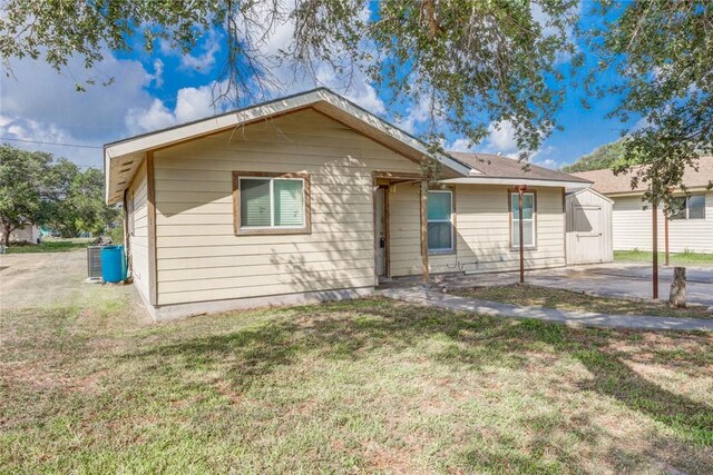 529 Blanco St, Taft, TX 78390 - view of front of home with a shed and a front lawn