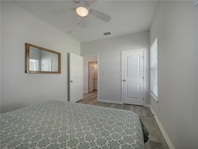 bedroom with light hardwood / wood-style floors and ceiling fan