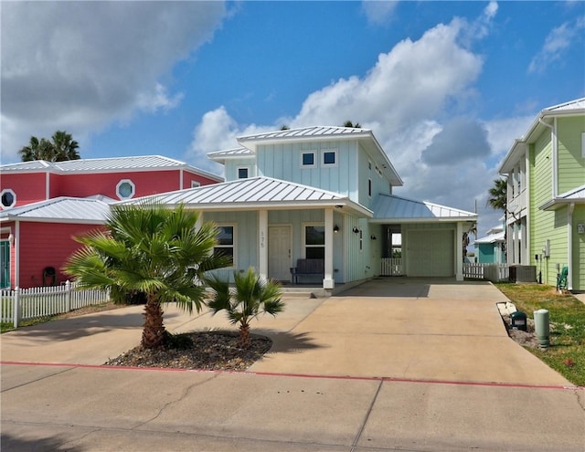 view of front of house with a carport, a garage, and covered porch