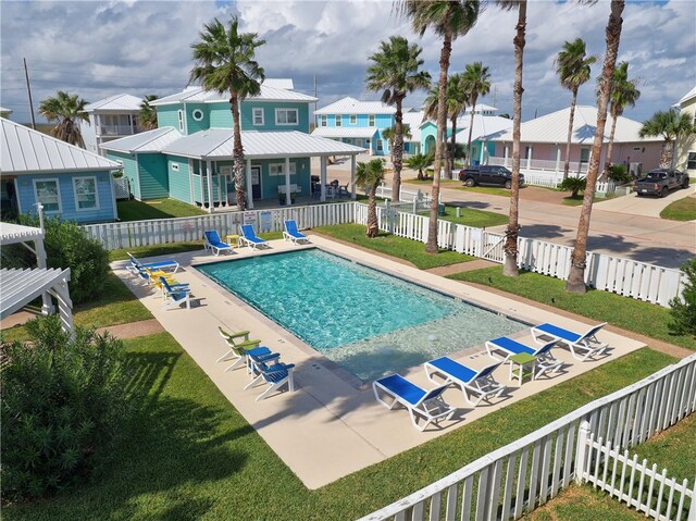 view of swimming pool with a patio area and a lawn