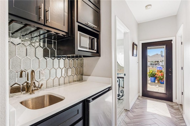15342 Cartagena Ct, Corpus Christi, TX 78418 - bar featuring stainless steel microwave, a sink, tasteful backsplash, dishwashing machine, and baseboards