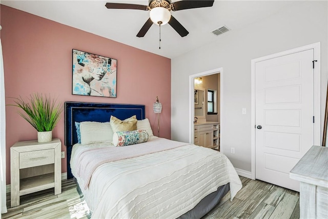 15342 Cartagena Ct, Corpus Christi, TX 78418 - bedroom with light wood finished floors, ensuite bathroom, baseboards, and a ceiling fan