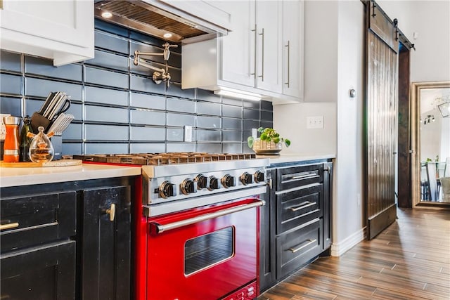 15342 Cartagena Ct, Corpus Christi, TX 78418 - kitchen featuring high end range, custom range hood, white cabinetry, a barn door, and backsplash