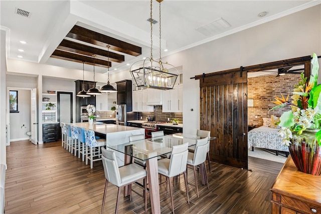 15342 Cartagena Ct, Corpus Christi, TX 78418 - dining room with a barn door, dark wood-style floors, beam ceiling, baseboards, and recessed lighting