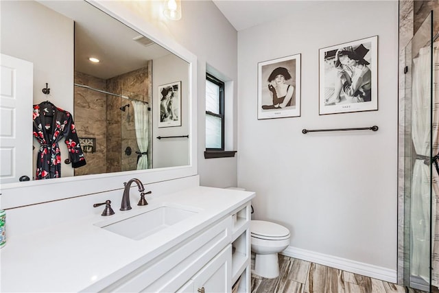 15342 Cartagena Ct, Corpus Christi, TX 78418 - full bathroom with toilet, vanity, a tile shower, and baseboards