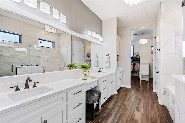 15342 Cartagena Ct, Corpus Christi, TX 78418 - full bathroom featuring a stall shower, double vanity, wood finished floors, and a walk in closet