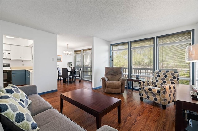 living area with a textured ceiling, dark wood-type flooring, and a wealth of natural light