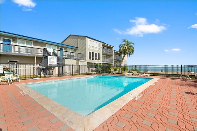 pool featuring a patio area and fence