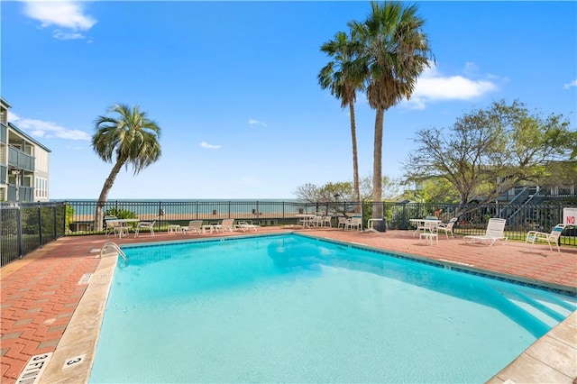 pool with fence and a patio