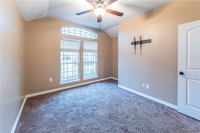 carpeted empty room with ceiling fan and vaulted ceiling