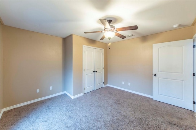 unfurnished bedroom featuring light colored carpet, a closet, and ceiling fan