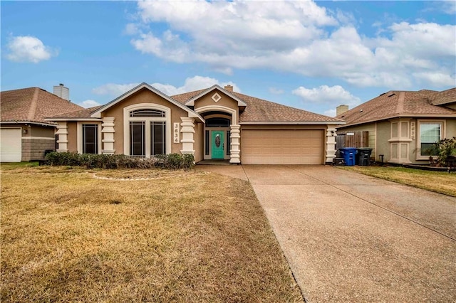 ranch-style home featuring a garage and a front yard