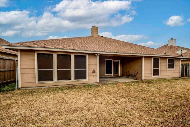 rear view of property with a yard and a patio