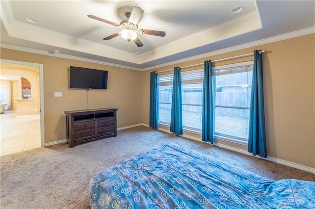 unfurnished bedroom featuring light carpet, crown molding, a raised ceiling, and ceiling fan