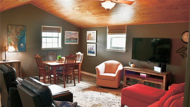 living room featuring wooden ceiling, a healthy amount of sunlight, light hardwood / wood-style flooring, and vaulted ceiling