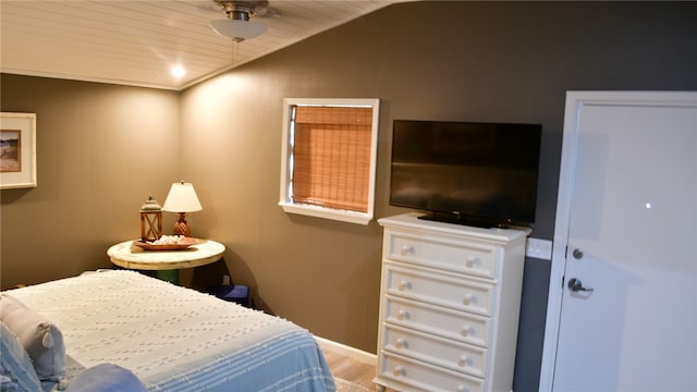 bedroom featuring hardwood / wood-style floors, wooden ceiling, and lofted ceiling